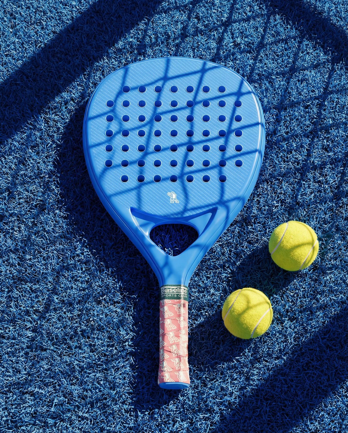Blue paddle with pink handle on a blue textured surface with two yellow balls.